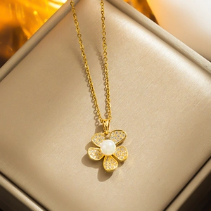 18k gold flower necklace with center pearl and pavé diamond petals on a fine gold chain
