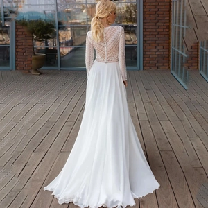 Elegant white long sleeve lace wedding dress with satin train and button back detail