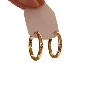 Classic minimalist golden metal round hoop earrings for women in a sleek polished finish