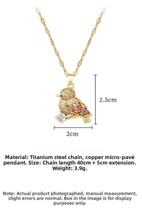 Detailed view of micro-paved zircon bird pendant with 40+5cm gold titanium steel chain