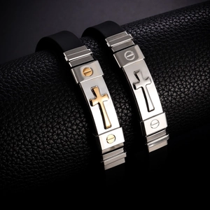 Black silicone bracelets for men with stainless steel cross plaque on leather background