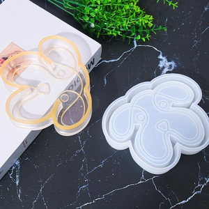 Detail of dog-shaped silicone mold with a gold glitter resin tray craft project
