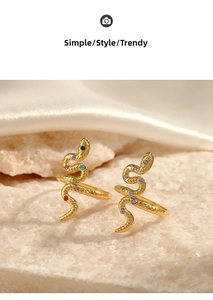 Detail shot of golden snake ring with colorful crystal stones on a stone base