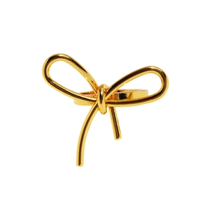 Elegant gold bow-shaped metal ring with smooth polished finish on white background