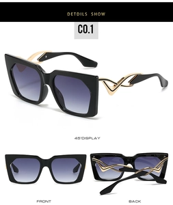Detail view showing gold flame accents and gradient lenses on oversized square sunglasses