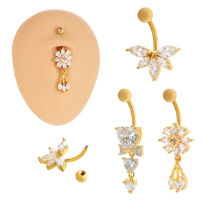 Set of four gold-plated flower and heart belly rings with zircon tassels on a model