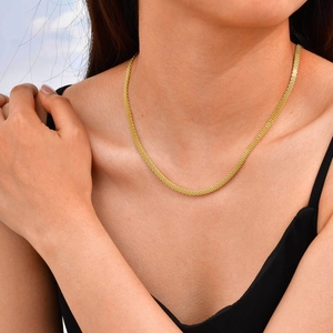 Gold stainless steel mesh chain necklace worn by a model to show elegant collarbone style