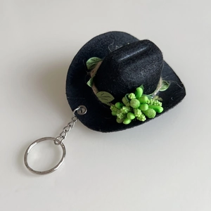 Detailed close-up of a mini 8cm black felt cowboy hat keychain with green bead accents