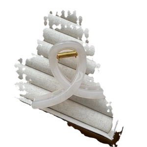 Minimalist jelly color hair claw clip in creamy white resin with elegant twisted design