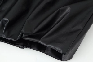 Macro shot of high-quality black leather texture with fine stitching and fold details