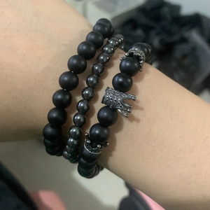 Luxury beaded men's bracelets featuring matte black stone beads and silver lion crown charm