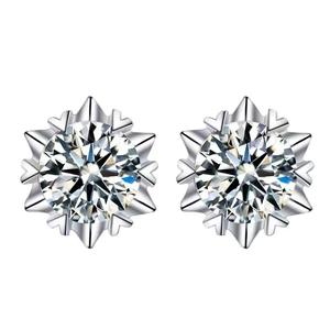 Macro shot of silver snowflake earrings featuring brilliant round cut center stones