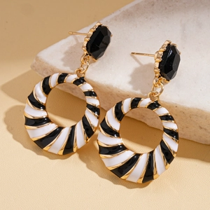 Detailed view of vintage geometric striped drop earrings with black diamond accents