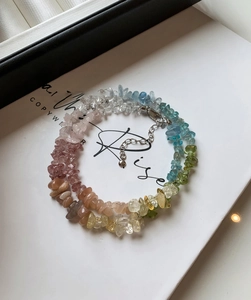 Close-up of double-layer colorful semi-precious stone bracelet with silver lobster clasp