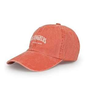Detail view of vintage washed coral orange baseball cap with white LOS ANGELES embroidery