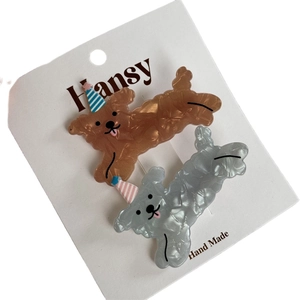 Lot de deux jolies barrettes chien en acétate texture marbrée avec chapeaux de fête