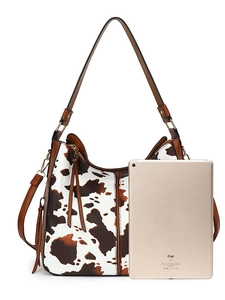 Retro cow print leather tote bag in brown and white with tassel and adjustable strap