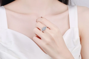 Close-up of 3-carat moissanite ring with side stones on a finger in luxury style