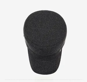 Top view of dark grey wool flat top cap for elderly men with refined metal logo detail