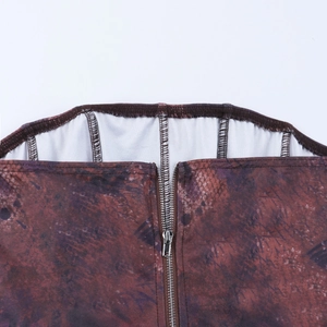 Detailed close-up of a silver metal zipper on reddish-brown textured fabric