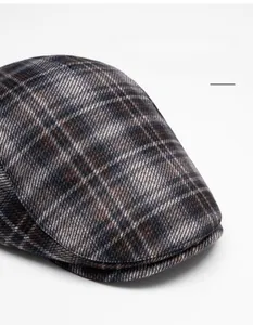Detail view of foldable wider brim on vintage dark plaid beret with wool texture