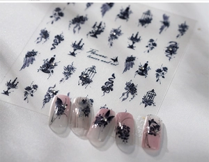 Detail of gothic black butterfly and flower nail stickers with 3D embossed crystal accents