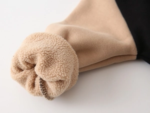 Detailed close-up of thick fleece lining and stitched cuff on a warm winter jacket