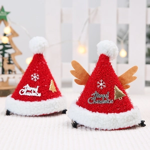 Christmas hair clips featuring mini red Santa hats with reindeer antlers and snowflakes