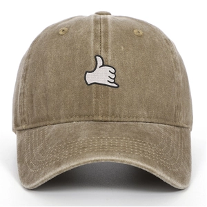 Close-up of khaki washed cotton baseball cap featuring a white Shaka hand embroidery