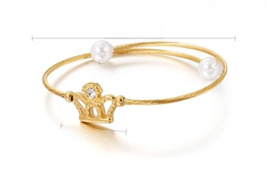 Detailed view of golden stainless steel crown bracelet with 8mm shell pearls and specs
