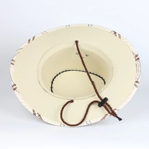 Detail view of woven straw cowboy hat featuring adjustable brown drawstring with toggle