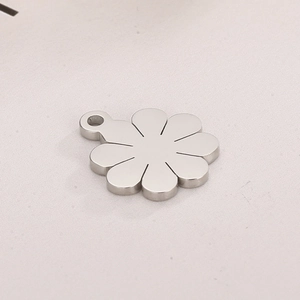 Detailed view of a hollow rose flower pendant in silver stainless steel for DIY jewelry