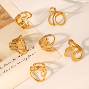 Detail view of six textured 18K gold plated stainless steel open rings with wavy designs