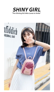 Outdoor street style shot of a mini pink sequin backpack for women with brand logo