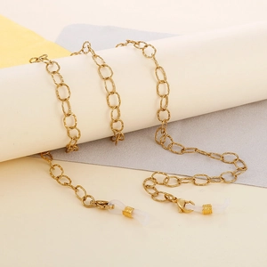 Detail of gold titanium steel eyewear chain with lobster clasp and silicone loop connectors