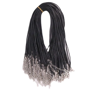 Bundle of black necklace cords with silver lobster clasps and extension chains on white