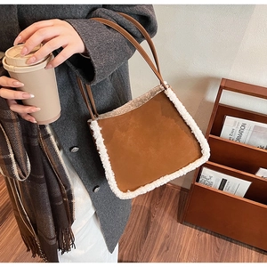 Chic brown suede tote bag with white faux fur trim shown in a warm street style setting