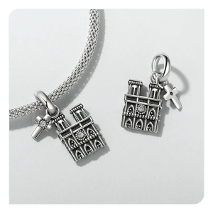 Detailed close-up of S925 sterling silver cathedral charms with miniature cross pendant