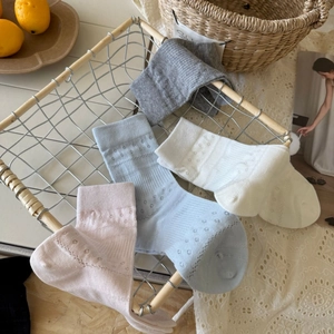 Detailed close-up of breathable cotton hollow-out knit mid-calf socks in pastel colors