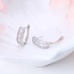 Macro detail of S925 sterling silver hoop earrings with sparkling micro-pave cubic zirconia