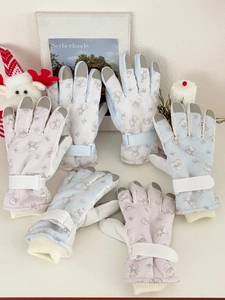 Detail of bunny print ski gloves featuring touchscreen fingertips and velcro wrist straps