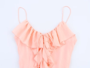 Detail of peach pink chiffon camisole with tiered ruffles and gold bead drawstring tie