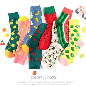 Detail view of colorful fruit pattern crew socks including lemon and banana prints