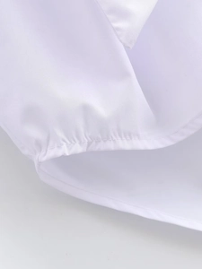 Close-up of white woven fabric texture with neat single-needle stitching and pleated detail