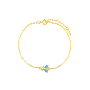 Detailed view of a gold bee charm bracelet with light blue enamel wings and thin link chain