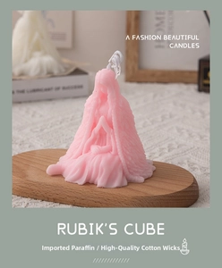 Artistic pink female figure scented candle on a wooden tray for home decor