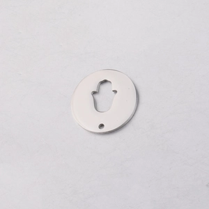 Macro shot of mirror polished stainless steel round charm with Hamsa Hand cutout