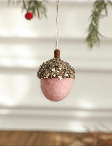 Detailed view of pink felt acorn ornament with gold sequins for Christmas decor