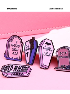 Detailed view of pink and purple gothic enamel pins set on a textured leather background
