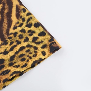 Detailed macro view of leopard print fabric stitching and texture for beach dress